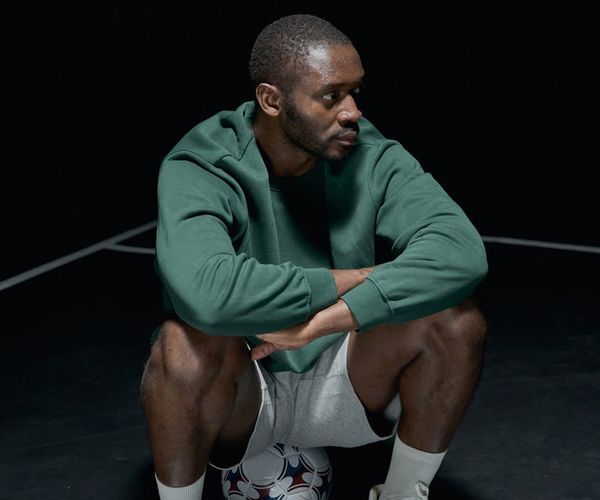 Man in sports wear sitting calmly and focusing on breathing