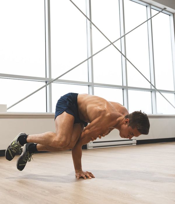 Strong man performing coordination balance exercises in gym